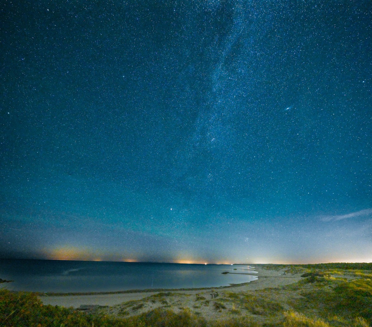 The Milky Way and a starry night sky above a Baltic Sea beach in Denmark