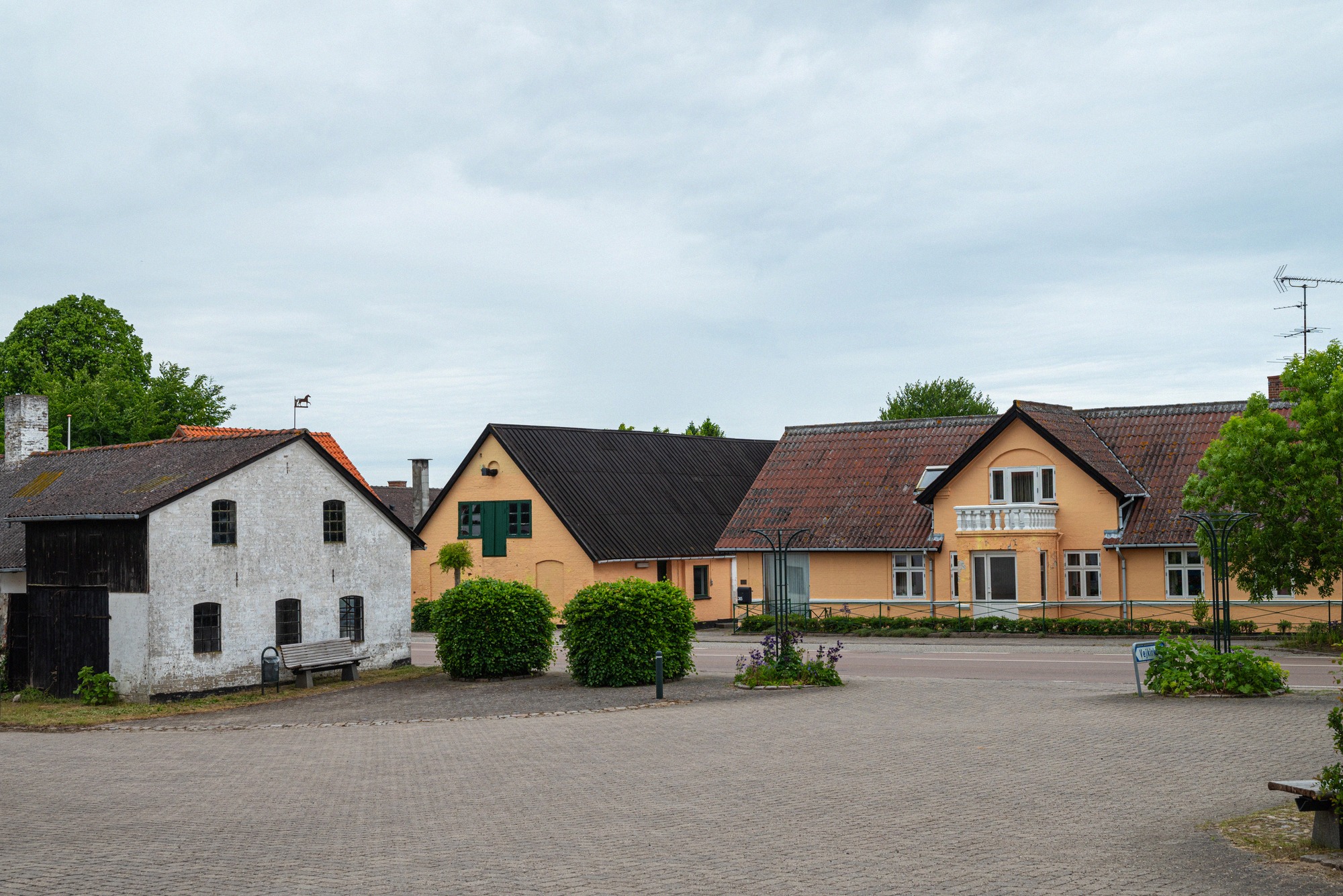 The village square of Borre. Cobbled village square in Borre with buildings in white and ochre