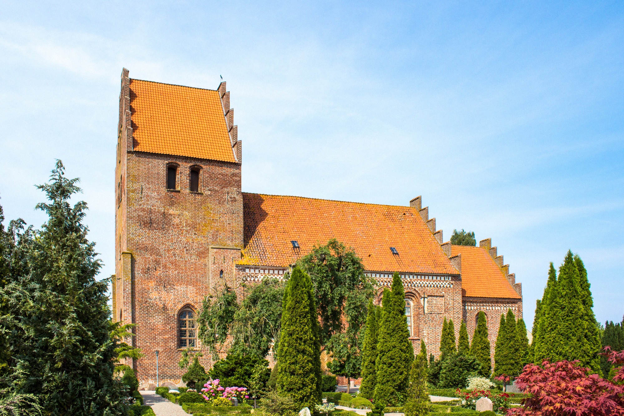 The old village church of Borre. The red-brick Borre Kirke with saddle roof and bell tower