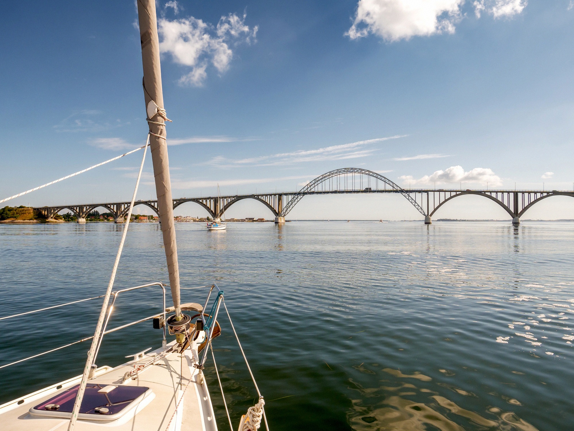 The Dronning Alexandrines Bridge links Zealand to Møn across the Ulvsund. View from a sailing boat of the Dronning Alexandrines Bro arch bridge over the Ulvsund