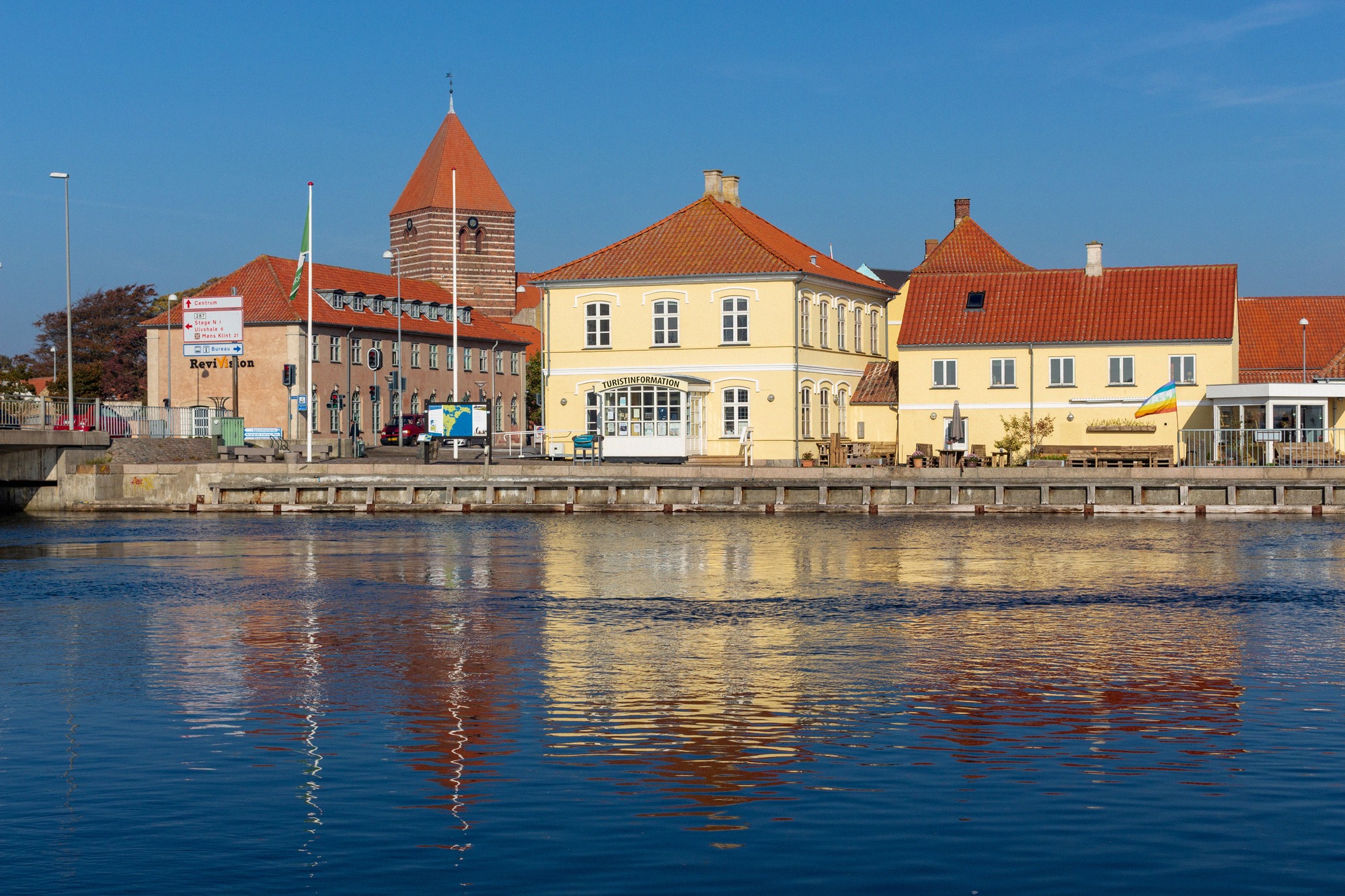 Stege Kirke, seen from the harbour. Stege Kirke with its red roof, reflected in the harbour water