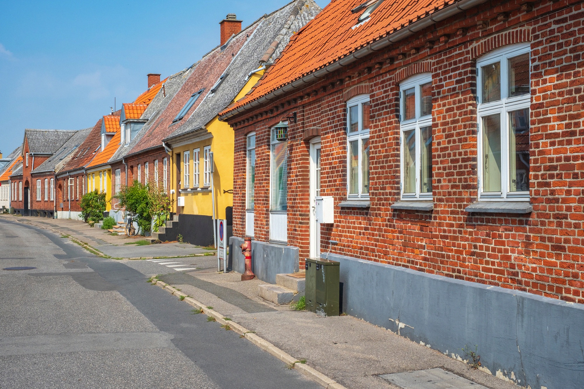 Brick houses with colourful façades in a side lane of Stege